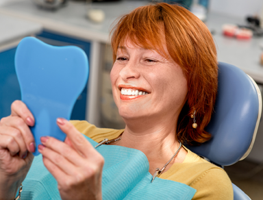 Patient Smiling in Mirror in Honolulu